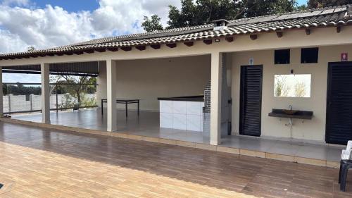 a large covered patio with a table on top at Recanto do boto in Anápolis