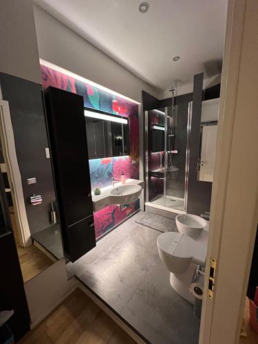 a bathroom with a sink and a toilet and a tub at COSENZA APARTMENT in Cosenza