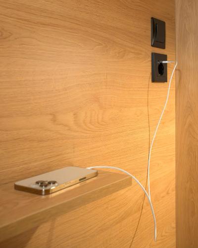 a electronic device plugged into a wall with a cord at Chania Capsule Stay in Chania