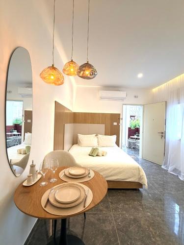 a bedroom with a bed and a table with plates on it at Pure Sense in Beʼer Ora
