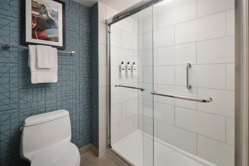 a bathroom with a glass shower with a toilet at Homewood Suites by Hilton Daytona Beach Speedway-Airport in Daytona Beach