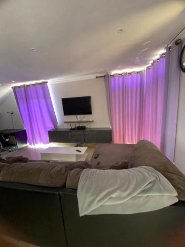 a bedroom with purple curtains and a large bed at Ocean Haven in Walvis Bay