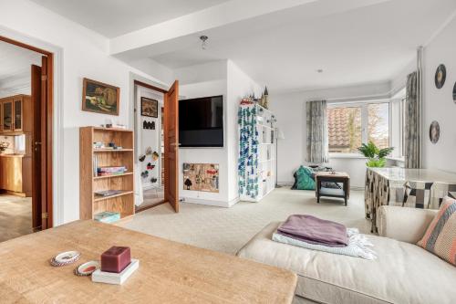a living room with a couch and a table at Cozy House Close to Beach and B&O in Struer
