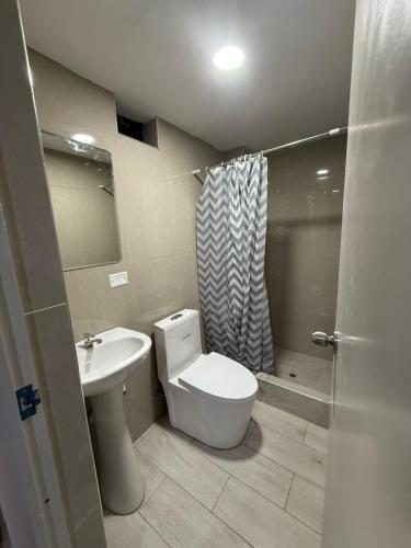 a bathroom with a toilet and a sink and a shower at Gran Estancia Vallecito in Arequipa