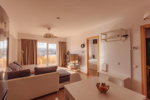 a living room with a couch and a table at ZEN Rezidential Apartments in Cluj-Napoca