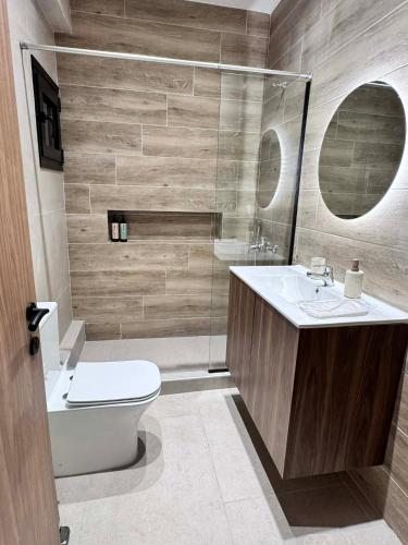 a bathroom with a toilet and a sink and a shower at Nest Studio in Katerini
