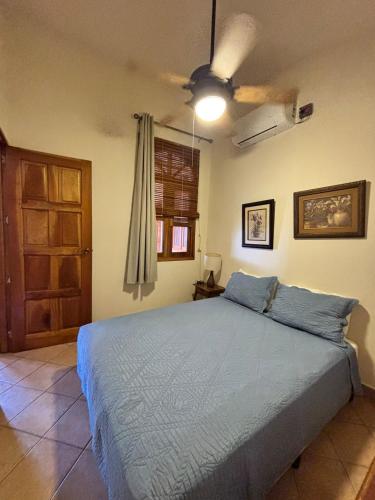 a bedroom with a bed and a ceiling fan at Seville Suite in San Juan del Sur