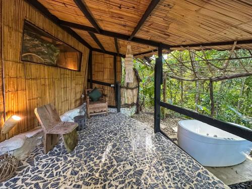 a bathroom with a tub and a chair and a toilet at Amara Hotel in Doradal