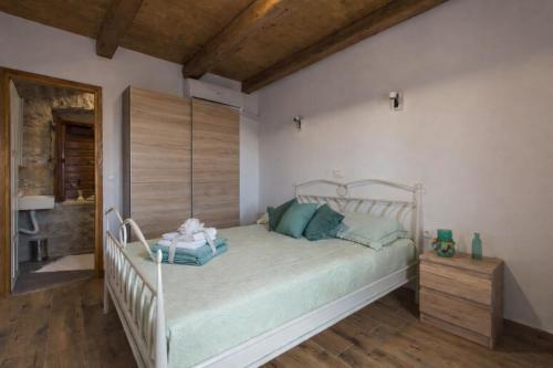 a bedroom with a bed with green pillows at Holiday home Dida Jere in Benkovac