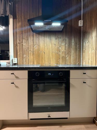 a kitchen with a stove and a counter top at Holiday Suite in Bugøynes
