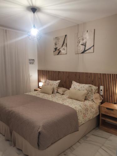 a bedroom with a large bed with pillows at Mi Capricho in Sitio de Calahonda
