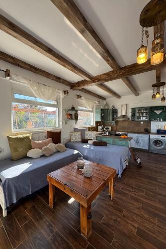 a living room with two beds and a table at Casa di Mare Stegna in Archangelos
