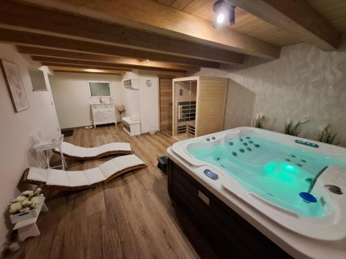 a bathroom with a large tub in a room at Hiša Skala Kubed in Gračišče