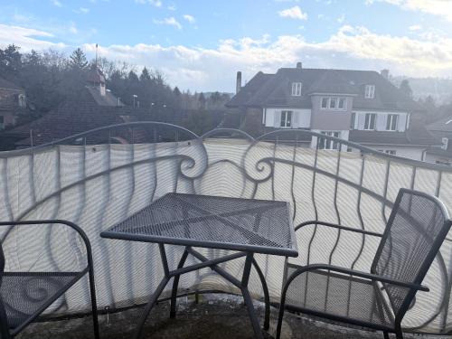 a table and chairs sitting on a balcony at Apartments Justingerweg Bern in Bern