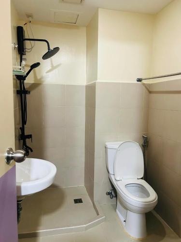 a bathroom with a toilet and a sink at Dysha's Home in Davao City