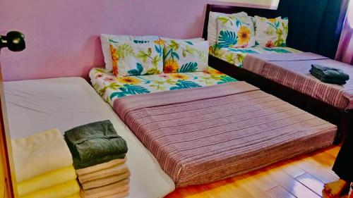 two twin beds in a room at Dysha's Home in Davao City