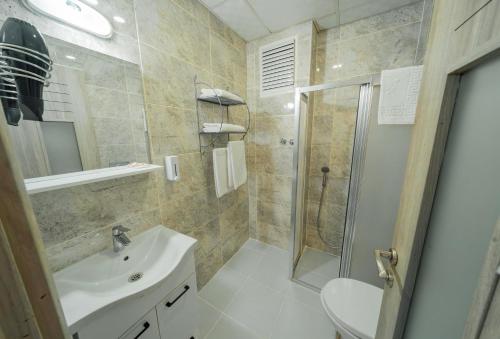 a bathroom with a shower and a sink and a toilet at City Life in İskenderun