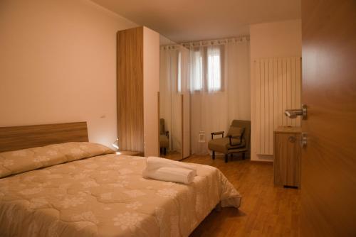 a bedroom with a bed and a chair in it at La Ruelle in Sulmona