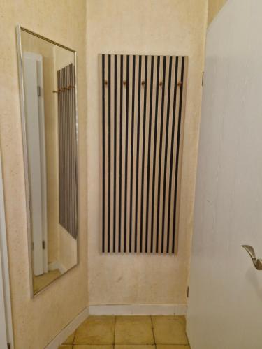 a bathroom with a door with a mirror on the wall at Mary´s Ferienwohnung in Kevelaer