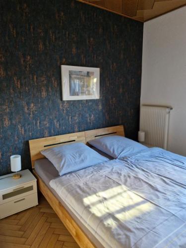 a bedroom with a bed with a blue wall at Mary´s Ferienwohnung in Kevelaer