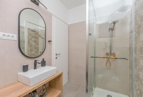 a bathroom with a sink and a shower at Apartments Blue Adriatic View in Jesenice
