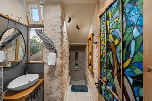 a bathroom with a large stained glass wall at Apartment Heritage Stonehouse in Ugljan