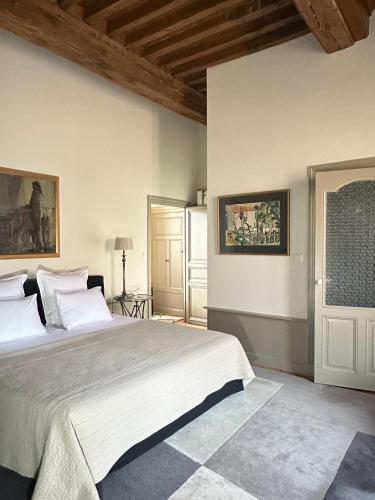 a bedroom with a large bed in a room at Demeure Bouquet in Ambierle