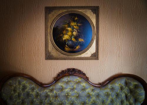 a picture of a painting on a wall with a couch at Oranienburg Vintage Hotel - Private Garden Residence in Vianden