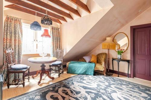 a bedroom with a bed and a table and chairs at The Wood Wing Suite at Bellspool in Peebles