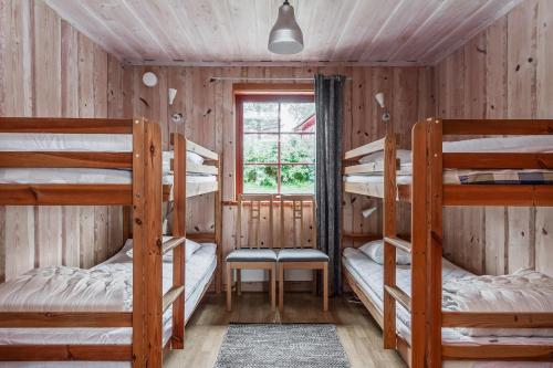 a room with three bunk beds and a window at Torsby Camping in Torsby