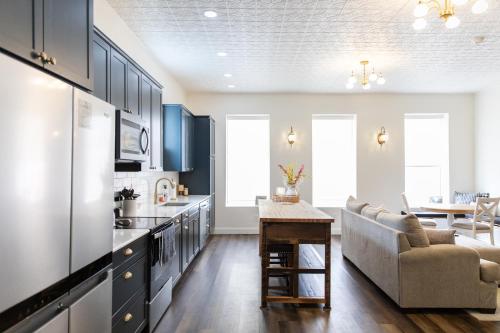 a kitchen with blue cabinets and a living room at Historic Market Plaza Overlook in Wheeling