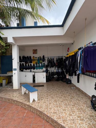 a room filled with clothes and a blue bench at Casamaya Hostel & Diving in Cozumel