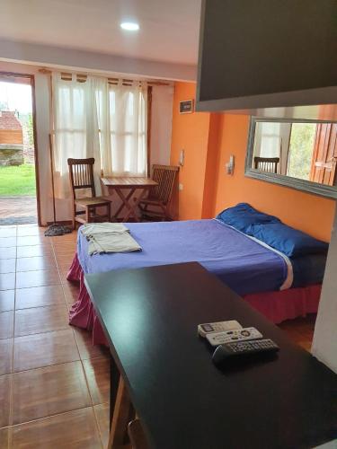 a bedroom with two beds and a table and a table sidx sidx sidx at Cabañas Villa Lounge in San Rafael