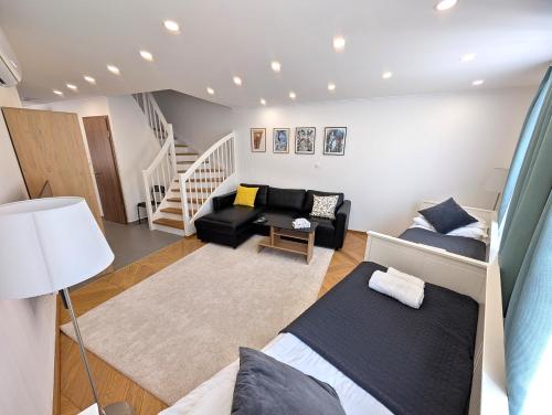 a living room with a bed and a couch at Monbuhim Four in Veszprém
