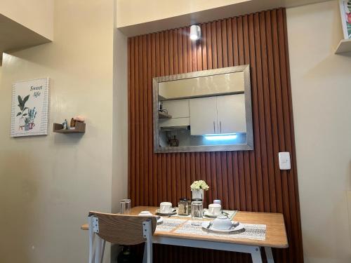 a table with a mirror on a wall at Avida Tower 3 L21 staycation rm 117 in Iloilo City