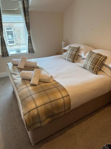 a large bed with two pillows in a bedroom at River-View Loft, sleeps 4, with parking in Inverness
