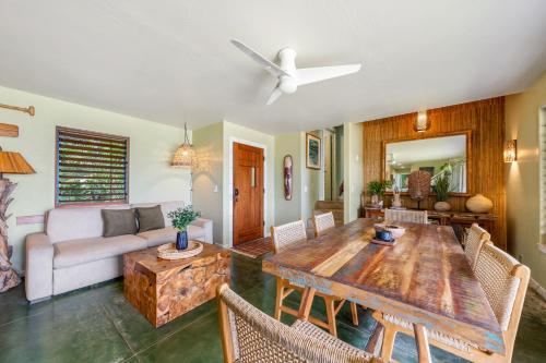 a living room with a table and a couch at Hale Kepuhi in Hanalei