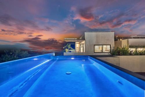 a swimming pool in front of a house at Piedras Luxe by Prestigia - Villa in Tulum