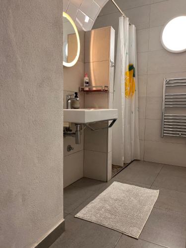 a bathroom with a sink and a refrigerator at Faro Town House in Faro