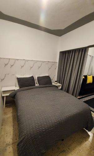 a bedroom with a large bed and a window at First Floor 2 Bed Apartment in La Ceiba