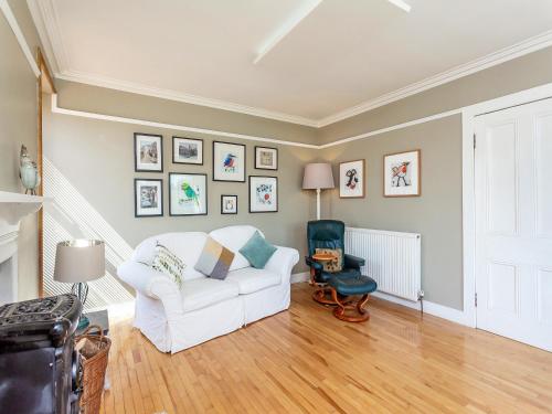 a living room with a white couch and a chair at The Laurels in Nairn