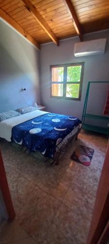 a bedroom with a bed in a room with a wooden ceiling at Cabañas Donato in Colonia Benítez