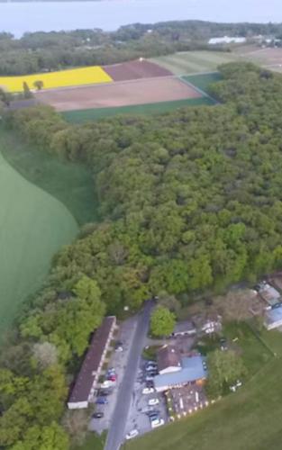 an aerial view of a parking lot next to a lake at Relais de l'Aérodrome in Prangins