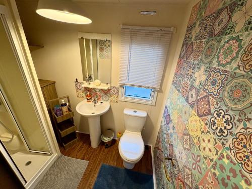 a small bathroom with a toilet and a sink at Jazmine's Place in Ayr