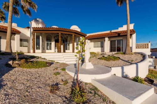 a house with palm trees in front of it at Recently Renovated Oceanview Home Casa Hebe in Puerto Peñasco