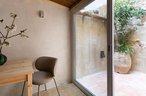 a room with a desk and a chair next to a sliding glass door at Calderona Tiny house in Segorbe