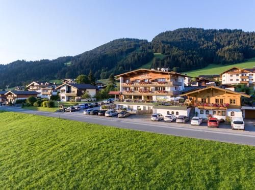 a town in the mountains with cars parked on a road at Hotel Ritterhof Ellmau in Ellmau