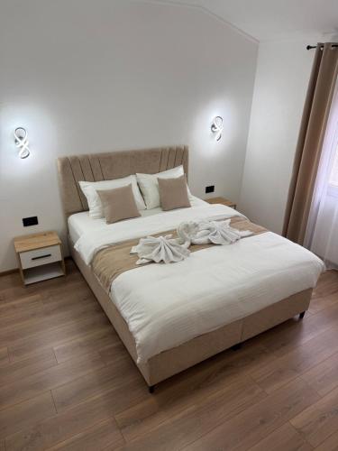 a bedroom with a large bed with white sheets at Apartman Đole&Ljuba -Radanovići , Kotor in Ðuranovići