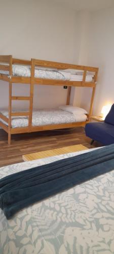 two bunk beds in a room with a bed at Cristel Malpensa apartment in Cardano al Campo