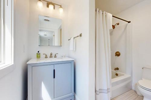 a white bathroom with a sink and a toilet at Lakeshore Retreat in Gilford